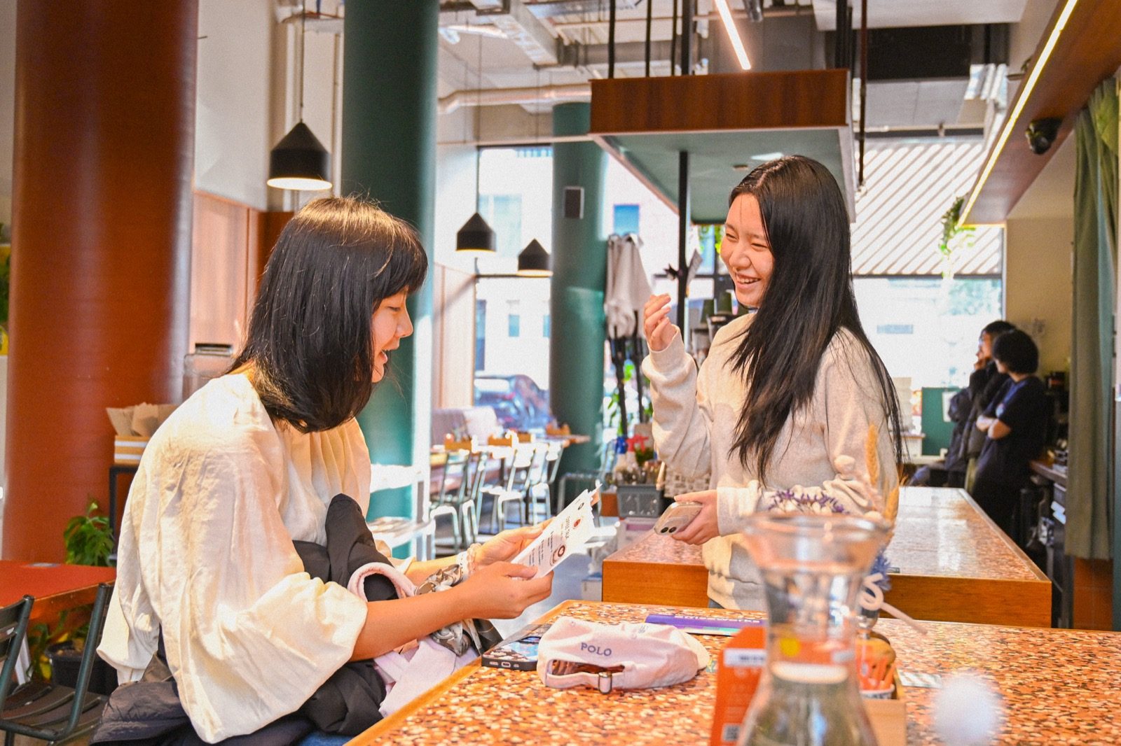 Two people chatting over coffee at the Yapify gathering