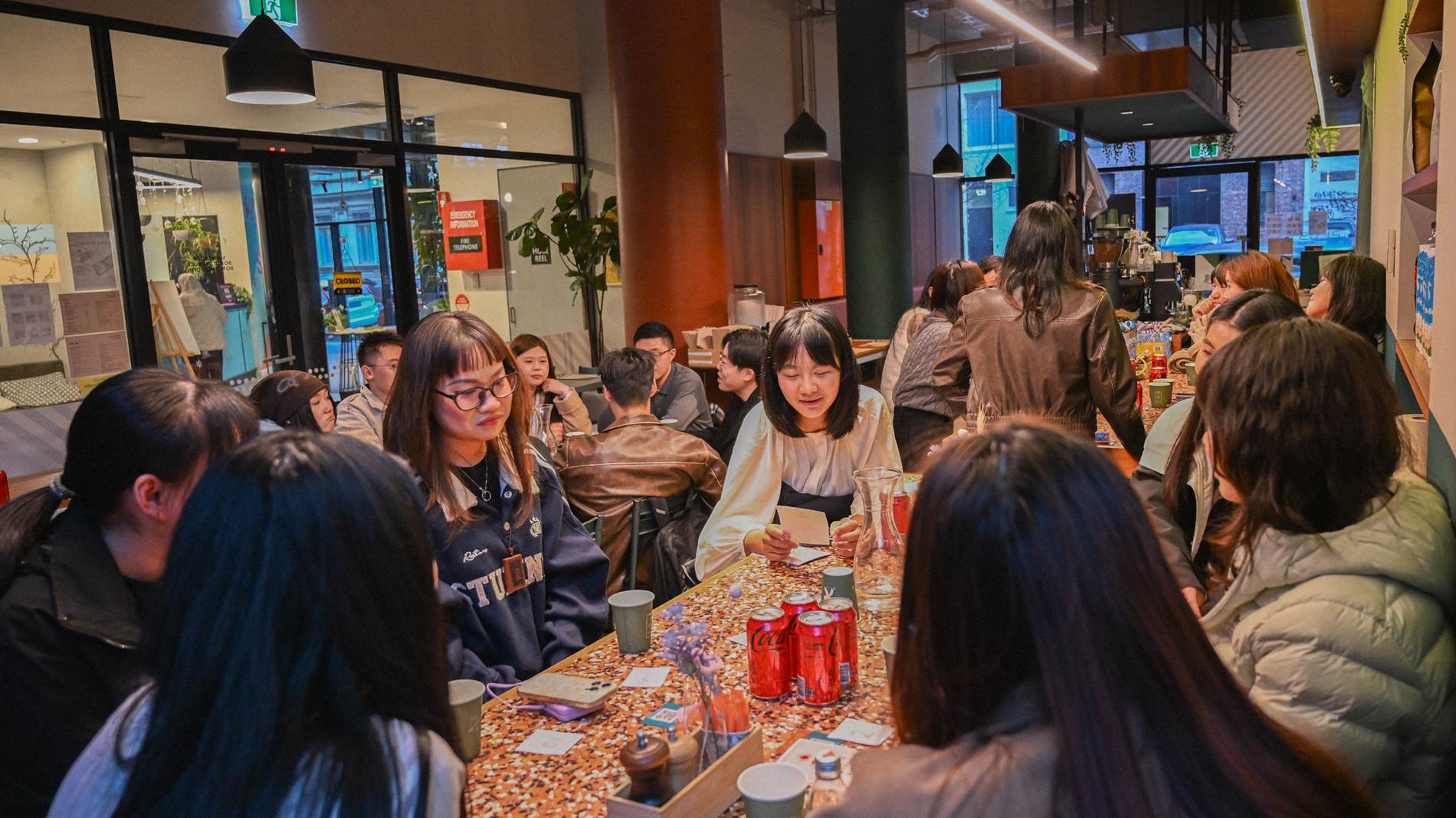 People sitting together at a long table at a Yapify community gathering in Melbourne